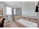 Spa-like bathroom featuring a soaking tub, shower, and updated fixtures at 19577 Meta Rd, Cornelius, NC 28031