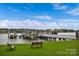 Community boat dock with several slips and benches on a calm lake at 19577 Meta Rd, Cornelius, NC 28031