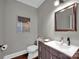 Modern powder room features a floating vanity and wood-look flooring at 19577 Meta Rd, Cornelius, NC 28031