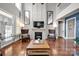 Spacious living room with hardwood floors, fireplace, and high ceilings at 19577 Meta Rd, Cornelius, NC 28031