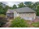 Home's back exterior, featuring a screened porch and landscaping at 148 N Ott Dyson Nw Ctr # 1125, Taylorsville, NC 28681