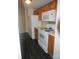 Kitchen features wood cabinets, laminate flooring, and white appliances at 1600 H Arlyn Cir, Charlotte, NC 28213