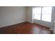 Simple bedroom with laminate flooring and large window at 1600 H Arlyn Cir, Charlotte, NC 28213
