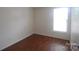 Spacious bedroom with wood-look laminate floor and a window at 1600 H Arlyn Cir, Charlotte, NC 28213