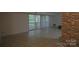 Spacious living room with tile floors and sliding glass doors at 9500 L Shannon Green Dr, Charlotte, NC 28213