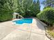 Inviting in-ground pool with a spacious concrete patio and slide at 5901 Morgan Park Dr, Monroe, NC 28110