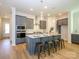 Modern kitchen with gray cabinetry, quartz countertops, and island at 1314 Idyllic Ln, Waxhaw, NC 28173