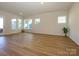 Spacious living room featuring light hardwood floors and abundant natural light at 1314 Idyllic Ln, Waxhaw, NC 28173