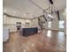 Open kitchen with island, stainless steel appliances, and hardwood floors at 4020 Landsford Rd, Marshville, NC 28103