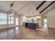 Spacious kitchen with island, white cabinets, and hardwood floors at 4020 Landsford Rd, Marshville, NC 28103