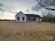 White farmhouse style home with a covered patio at 4020 Landsford Rd, Marshville, NC 28103