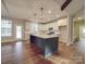 Modern kitchen featuring an island, white cabinets, and hardwood floors at 4020 Landsford Rd, Marshville, NC 28103