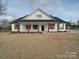 White farmhouse exterior with a covered front porch and dark brown columns at 4020 Landsford Rd, Marshville, NC 28103