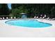 Relaxing kidney-shaped pool with lounge chairs at 182 Shagbark Ct, Mount Gilead, NC 27306