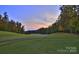 Scenic golf course view at sunset, showcasing lush greens and fairways at 182 Shagbark Ct, Mount Gilead, NC 27306