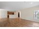 Spacious living room with hardwood floors and views into kitchen at 1900 Mt Isle Harbor Dr, Charlotte, NC 28214