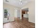 Bright sunroom with hardwood floors, access to backyard, and views into kitchen at 1900 Mt Isle Harbor Dr, Charlotte, NC 28214