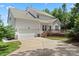 Two-story house with attached garage and deck, spacious driveway and backyard at 1900 Mt Isle Harbor Dr, Charlotte, NC 28214