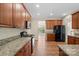Kitchen with wooden cabinets, granite countertops, and breakfast bar at 1900 Mt Isle Harbor Dr, Charlotte, NC 28214