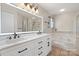 Elegant bathroom with double vanity, large mirror, and soaking tub at 1900 Mt Isle Harbor Dr, Charlotte, NC 28214