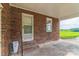 Covered side entrance with brick steps and exterior door at 37 Clemmons Rd, Wadesboro, NC 28170