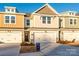 Townhouse exterior featuring a neutral color scheme and two-car garage at 136 Halite Ln, Waxhaw, NC 28173