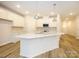 Modern kitchen with white cabinets, quartz countertops and stainless steel appliances at 136 Halite Ln, Waxhaw, NC 28173