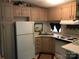 Galley kitchen with white appliances and ample cabinetry at 103 Holly Harbor Trl # A348, Mount Gilead, NC 27306