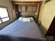 Main bedroom with a queen-size bed and overhead cabinets at 113 Hummingbird Cir, New London, NC 28127