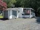 Mobile home with screened porch and adjacent storage shed at 113 Hummingbird Cir, New London, NC 28127