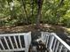 Wooded backyard accessed by stairs from deck at 113 Hummingbird Cir, New London, NC 28127