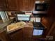 Full-sized kitchen in an RV featuring a double sink and gas cooktop at 113 Hummingbird Cir, New London, NC 28127