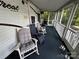Spacious screened porch with rocking chairs, offering a peaceful retreat at 113 Hummingbird Cir, New London, NC 28127