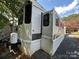 Side view of mobile home showing exterior features at 113 Hummingbird Cir, New London, NC 28127