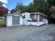 Mobile home with shed and spacious screened porch at 113 Hummingbird Cir, New London, NC 28127