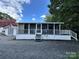 Mobile home with screened porch and small shed at 113 Hummingbird Cir, New London, NC 28127