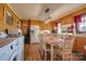 Kitchen with wood cabinets, a dining area, and laundry area access at 148 Hudson Ln, Statesville, NC 28625