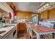 View of kitchen with wood cabinets, eat-in area, and appliances at 148 Hudson Ln, Statesville, NC 28625