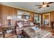 Relaxing living room with brown leather furniture and a view into the laundry area at 148 Hudson Ln, Statesville, NC 28625