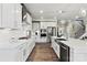 Modern kitchen with white cabinets, stainless steel appliances, and large island at 211 Coronado Ave # 57, Matthews, NC 28104