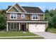 Two story home with stone and siding exterior and attached garage at 211 Coronado Ave # 57, Matthews, NC 28104