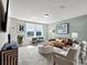 Comfortable living room featuring a cozy leather sofa and large windows at 211 Coronado Ave # 57, Matthews, NC 28104