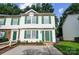 Two-story townhouse with green shutters and a patio at 2876 Hosta Dr, Charlotte, NC 28269