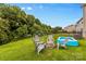 Relaxing backyard with firepit, inflatable pool, and seating at 133 Lassen Ln, Mooresville, NC 28117