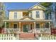 Charming yellow house with wrap-around porch and white picket fence at 121 W End St, Chester, SC 29706