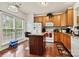 Kitchen features wood cabinets, granite island, and breakfast bar at 9622 Blossom Hill Dr, Huntersville, NC 28078