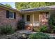 Front porch of a brick house with steps and surrounding plants at 1890 Rhyneland Rd, Lincolnton, NC 28092