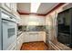 Galley kitchen with white cabinets, granite counters, and stainless steel appliances at 1890 Rhyneland Rd, Lincolnton, NC 28092