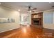 Living room featuring hardwood floors, fireplace, and kitchen view at 1890 Rhyneland Rd, Lincolnton, NC 28092