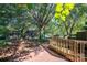Landscaped side yard with brick path and wooden fence at 1890 Rhyneland Rd, Lincolnton, NC 28092